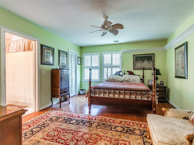 9 Country Club Rd, Shawnee, OK 74801 - bedroom with wood finished floors, a textured ceiling, ceiling fan, and baseboards