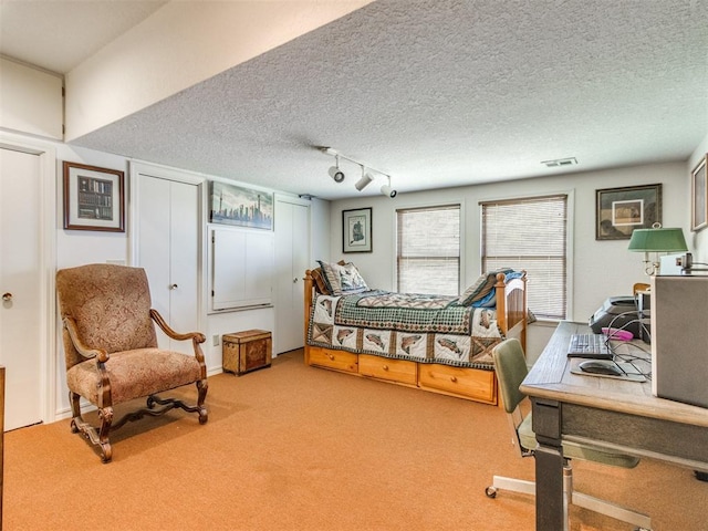 9 Country Club Rd, Shawnee, OK 74801 - carpeted bedroom with a textured ceiling and track lighting