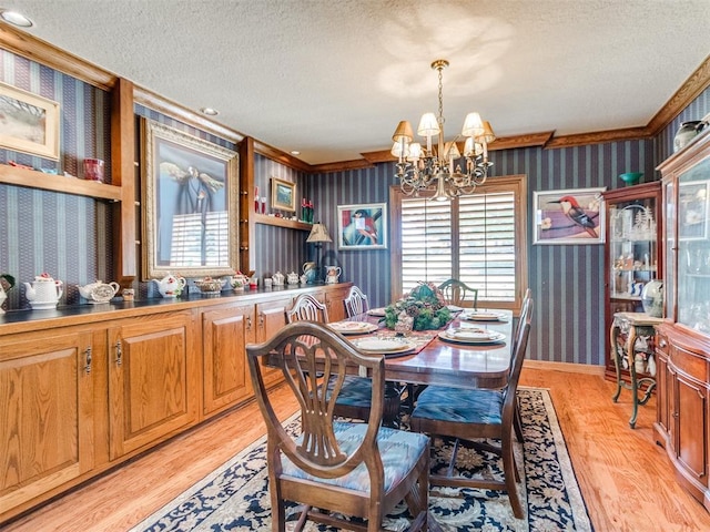 9 Country Club Rd, Shawnee, OK 74801 - dining space featuring wallpapered walls, a textured ceiling, a chandelier, and light wood-style flooring