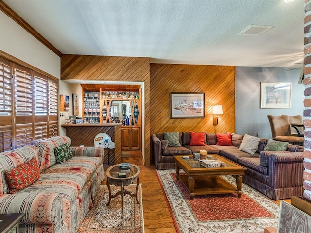 9 Country Club Rd, Shawnee, OK 74801 - living area featuring wooden walls, a textured ceiling, and wood finished floors