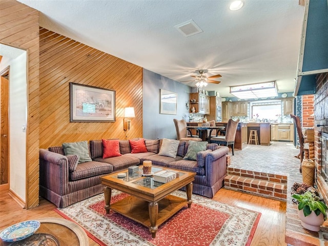 9 Country Club Rd, Shawnee, OK 74801 - living room featuring wooden walls, light wood-style floors, and ceiling fan