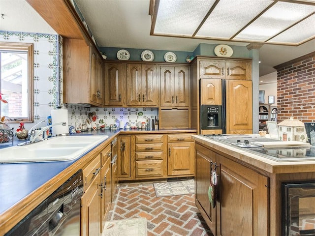 9 Country Club Rd, Shawnee, OK 74801 - kitchen with stovetop with downdraft, a sink, dishwasher, brick flooring, and paneled built in fridge