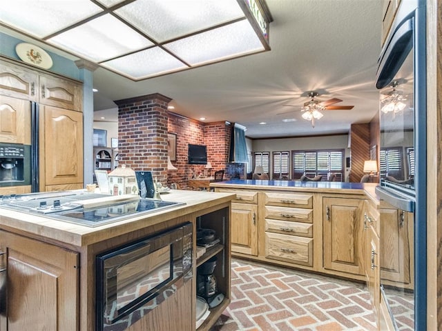 9 Country Club Rd, Shawnee, OK 74801 - kitchen featuring brick flooring, ceiling fan, stovetop with downdraft, a peninsula, and black microwave