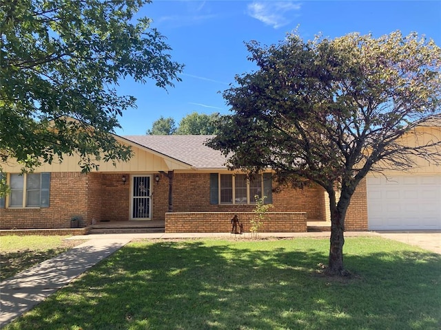 103 N Armor Ave, Canton, OK 73724 - ranch-style house with brick siding, a front lawn, and an attached garage
