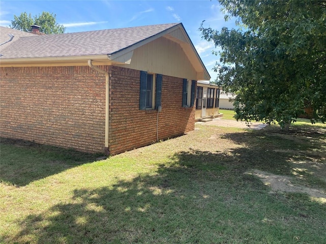 103 N Armor Ave, Canton, OK 73724 - view of home's exterior featuring brick siding, a yard, a shingled roof, and a chimney