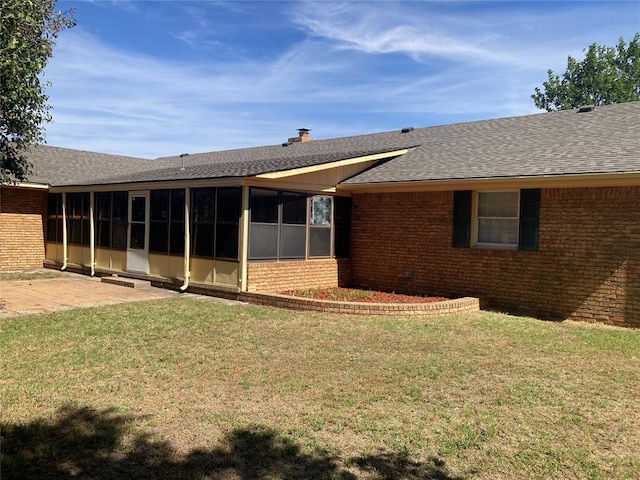 103 N Armor Ave, Canton, OK 73724 - rear view of house featuring brick siding, a sunroom, a shingled roof, and a yard