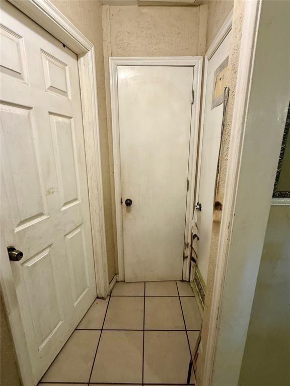 3427 Campbell Pl, Oklahoma City, OK 73108 - hallway with light tile patterned floors