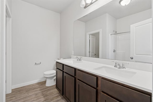 14308 Peach Tree Dr, Yukon, OK 73099 - bathroom featuring double vanity, wood finished floors, and a shower