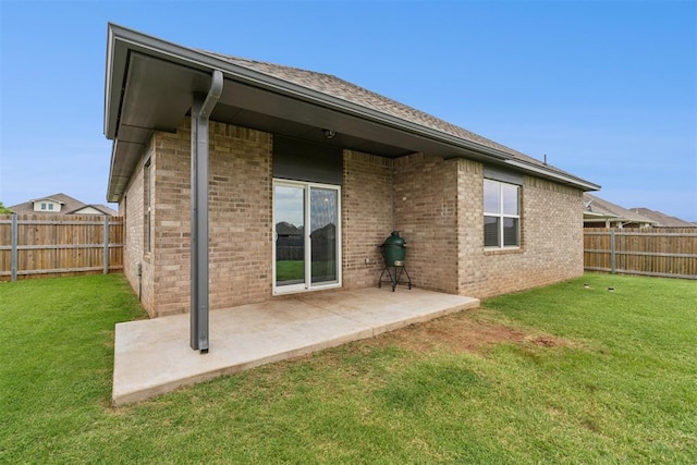14308 Peach Tree Dr, Yukon, OK 73099 - rear view of house with a fenced backyard, a patio area, and brick siding