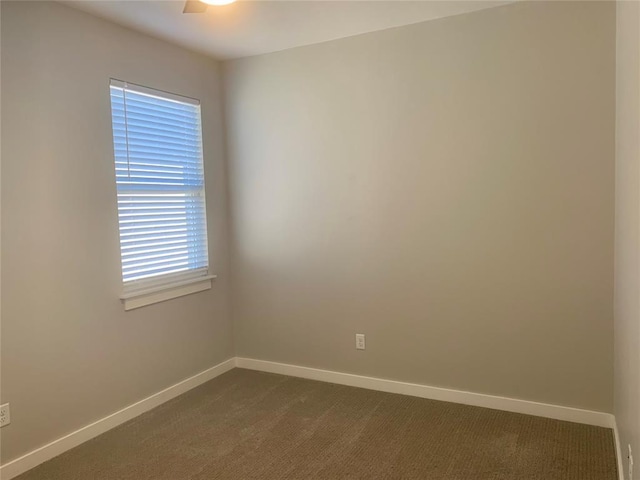 1305 NE 6th St, Oklahoma City, OK 73117 - spare room featuring baseboards and dark colored carpet