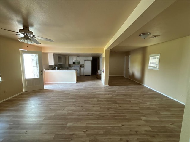 1540 Cross Rd, Altus, OK 29483 - unfurnished living room with healthy amount of natural light, wood finished floors, and ceiling fan