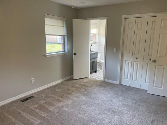3017 Kelsey Dr, Edmond, OK 73013 - unfurnished bedroom featuring carpet floors, baseboards, a closet, and connected bathroom