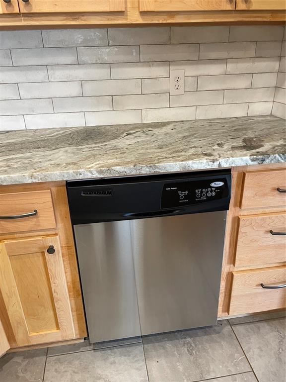 3017 Kelsey Dr, Edmond, OK 73013 - kitchen view of stainless steel dishwasher, decorative backsplash, and light stone counters