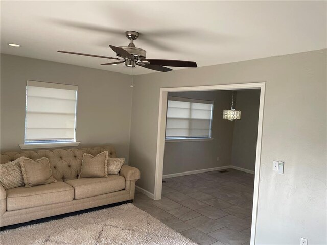 3017 Kelsey Dr, Edmond, OK 73013 - living area featuring built in shelves, a ceiling fan, and baseboards