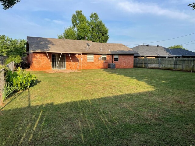 3017 Kelsey Dr, Edmond, OK 73013 - back of property featuring brick siding and central air condition unit