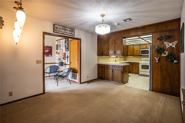 801 N Hunt St, Hydro, OK 73048 - kitchen with electric stove, stainless steel microwave, light colored carpet, light countertops, and a chandelier
