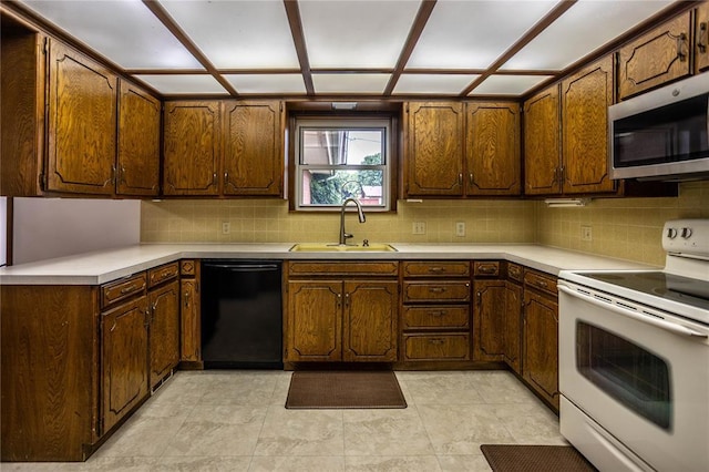801 N Hunt St, Hydro, OK 73048 - kitchen featuring electric range, black dishwasher, stainless steel microwave, tasteful backsplash, and light countertops