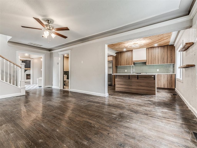 3157 NW 25th St, Oklahoma City, OK 73107 - kitchen featuring light countertops, dark wood-style floors, open floor plan, a ceiling fan, and backsplash