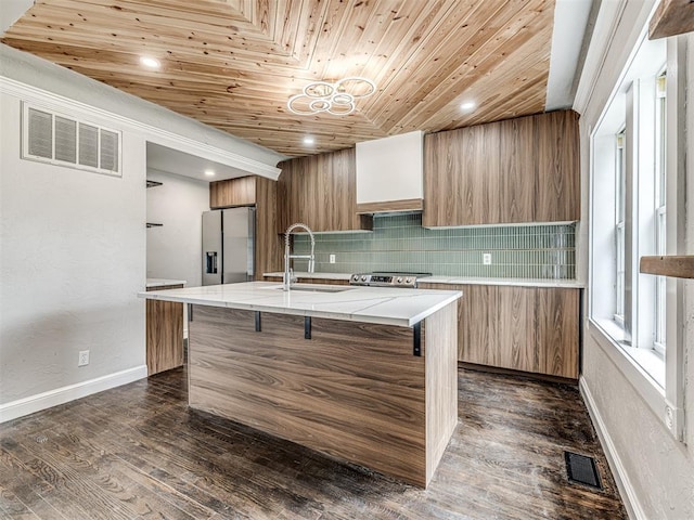 3157 NW 25th St, Oklahoma City, OK 73107 - kitchen featuring modern cabinets, appliances with stainless steel finishes, backsplash, brown cabinetry, and wooden ceiling