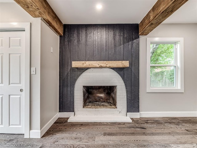 3157 NW 25th St, Oklahoma City, OK 73107 - detailed view of wood finished floors, a large fireplace, and beam ceiling