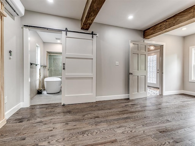 3157 NW 25th St, Oklahoma City, OK 73107 - entrance foyer with a wall mounted AC, a barn door, beamed ceiling, wood finished floors, and recessed lighting