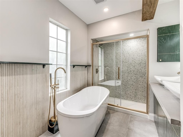 3157 NW 25th St, Oklahoma City, OK 73107 - bathroom with a freestanding tub, a shower stall, tile patterned flooring, and double vanity