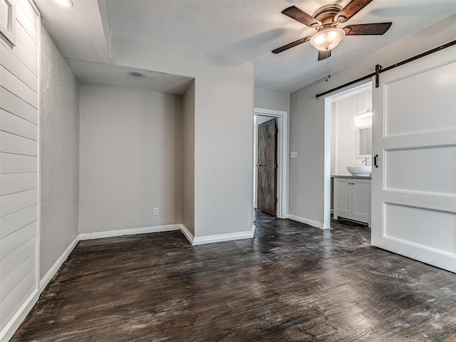 3157 NW 25th St, Oklahoma City, OK 73107 - unfurnished room featuring ceiling fan, a barn door, and wood finished floors