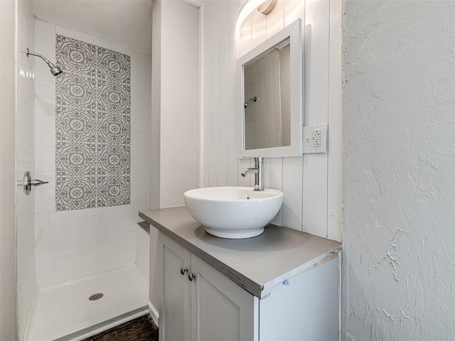 3157 NW 25th St, Oklahoma City, OK 73107 - bathroom with tiled shower, vanity, and a textured wall