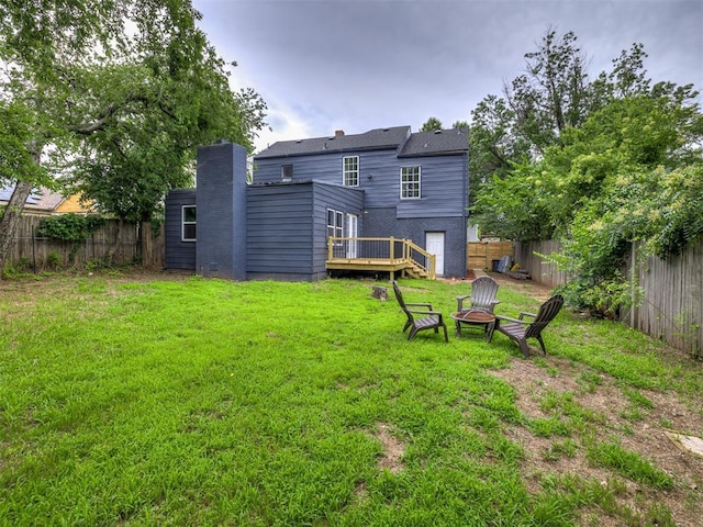 3157 NW 25th St, Oklahoma City, OK 73107 - back of house featuring a fire pit, a fenced backyard, a deck, and a chimney