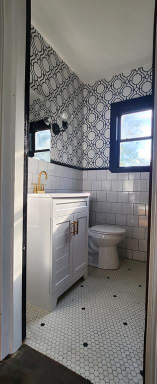 3157 NW 25th St, Oklahoma City, OK 73107 - bathroom featuring vanity, healthy amount of natural light, and tile walls