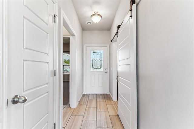 868 Phils Way, Piedmont, OK 73078 - doorway to outside featuring a barn door and baseboards