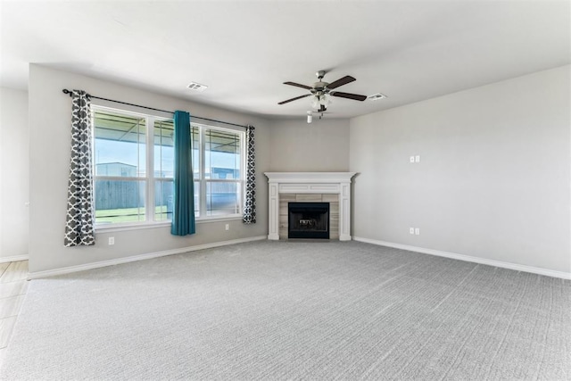 868 Phils Way, Piedmont, OK 73078 - unfurnished living room with ceiling fan, a tiled fireplace, and light carpet