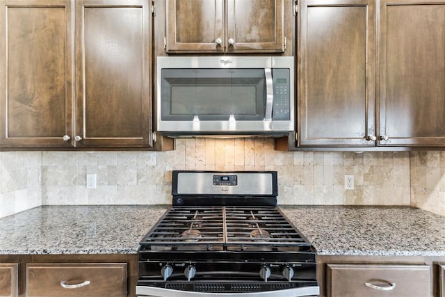 868 Phils Way, Piedmont, OK 73078 - kitchen with appliances with stainless steel finishes, dark brown cabinetry, and backsplash