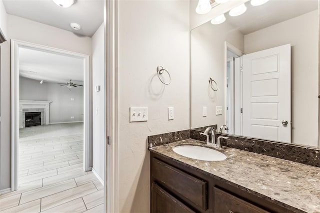 868 Phils Way, Piedmont, OK 73078 - bathroom with vanity, ceiling fan, and a tiled fireplace