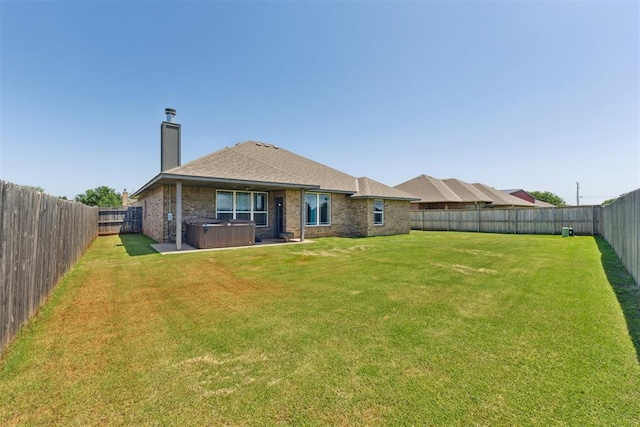 868 Phils Way, Piedmont, OK 73078 - back of house featuring a hot tub, a chimney, a fenced backyard, and brick siding