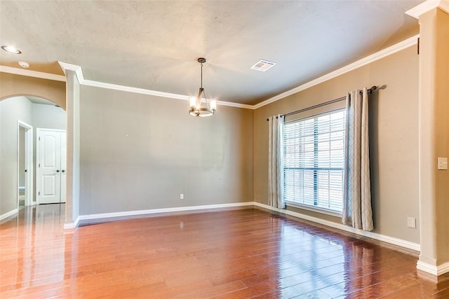 3393 Creek View Ct, Newcastle, OK 73065 - empty room featuring ornamental molding, wood finished floors, baseboards, and arched walkways