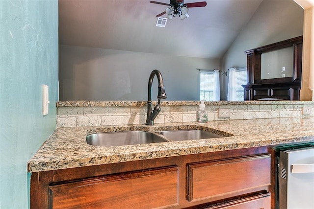3393 Creek View Ct, Newcastle, OK 73065 - kitchen featuring a sink, ceiling fan, vaulted ceiling, light stone countertops, and dishwashing machine