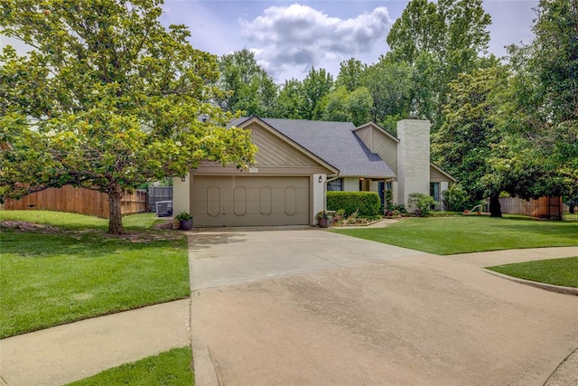 2010 Trailview Ct, Norman, OK 73072 - view of front of home featuring an attached garage, a chimney, concrete driveway, and roof with shingles