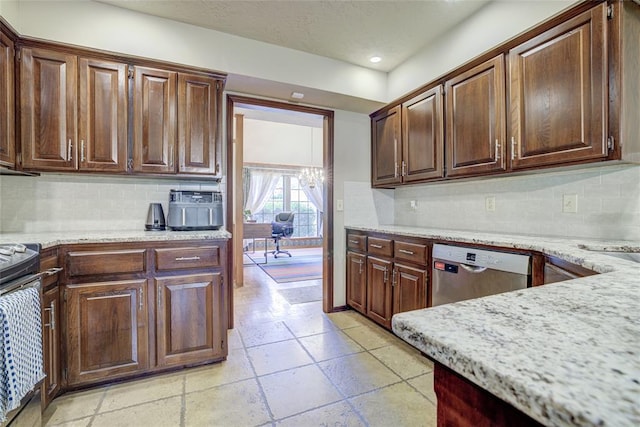 2010 Trailview Ct, Norman, OK 73072 - kitchen featuring appliances with stainless steel finishes, tasteful backsplash, light stone countertops, recessed lighting, and a chandelier
