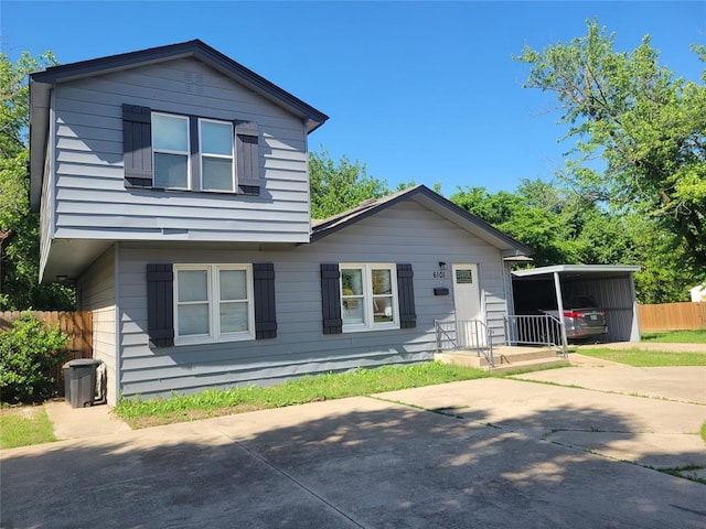 6101 NW 48th St, Warr Acres, OK 73122 - view of front facade with concrete driveway and a detached carport