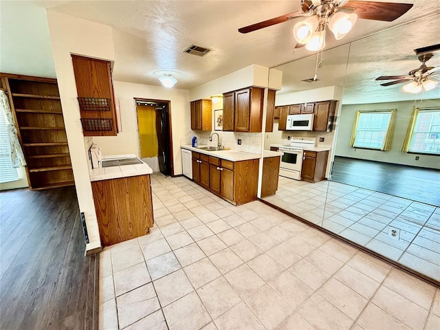 4400 Hemingway Dr Unit 263, Oklahoma City, OK 73118 - kitchen with white appliances, a sink, a ceiling fan, and light countertops