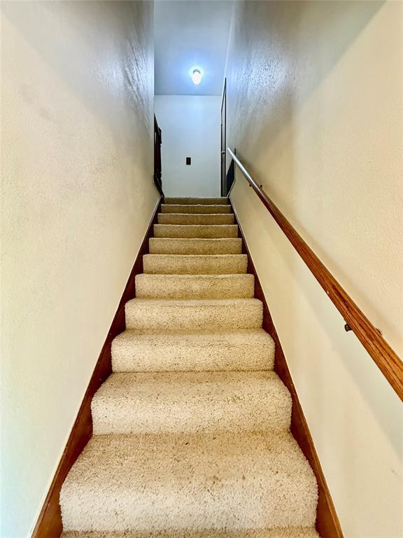 4400 Hemingway Dr Unit 263, Oklahoma City, OK 73118 - stairway featuring carpet flooring