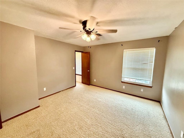 4400 Hemingway Dr Unit 263, Oklahoma City, OK 73118 - carpeted empty room with ceiling fan, baseboards, and a textured ceiling