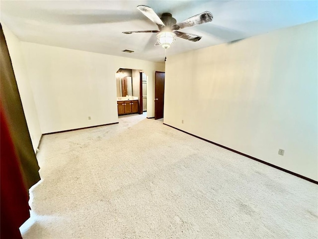4400 Hemingway Dr Unit 263, Oklahoma City, OK 73118 - unfurnished room featuring ceiling fan, baseboards, arched walkways, and light colored carpet