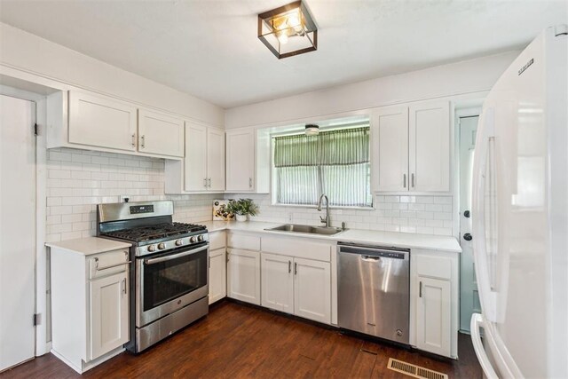 3029 NW 65th St, Oklahoma City, OK 73116 - kitchen featuring stainless steel appliances, light countertops, and white cabinetry