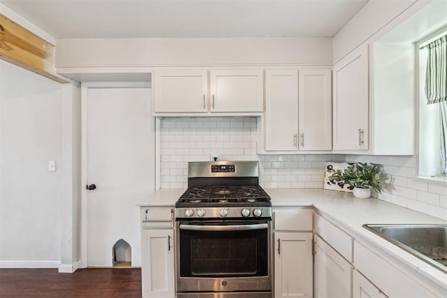 3029 NW 65th St, Oklahoma City, OK 73116 - kitchen with stainless steel gas range oven, dark wood finished floors, light countertops, and white cabinets