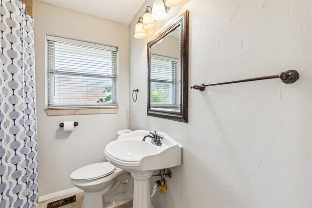 3029 NW 65th St, Oklahoma City, OK 73116 - bathroom with toilet and a shower with shower curtain