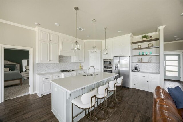 10800 NW 5th St, Yukon, OK 73099 - kitchen with stainless steel appliances, open shelves, dark wood-style floors, white cabinets, and crown molding