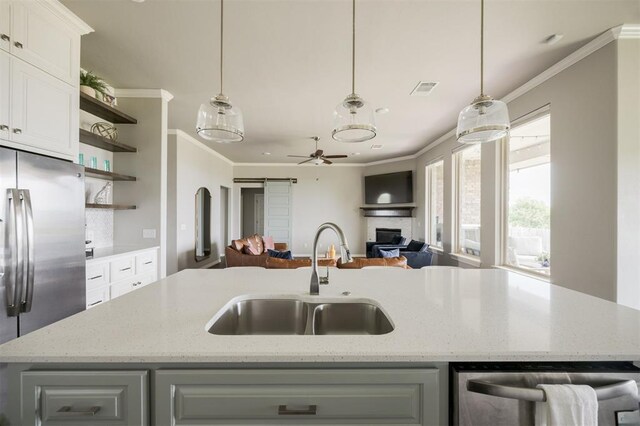 10800 NW 5th St, Yukon, OK 73099 - kitchen featuring open shelves, appliances with stainless steel finishes, open floor plan, ornamental molding, and a center island with sink
