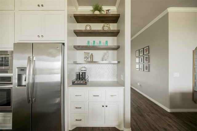 10800 NW 5th St, Yukon, OK 73099 - kitchen with appliances with stainless steel finishes, dark wood finished floors, crown molding, decorative backsplash, and light countertops